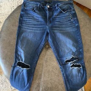 Dark wash skinny jeans with knee destruction